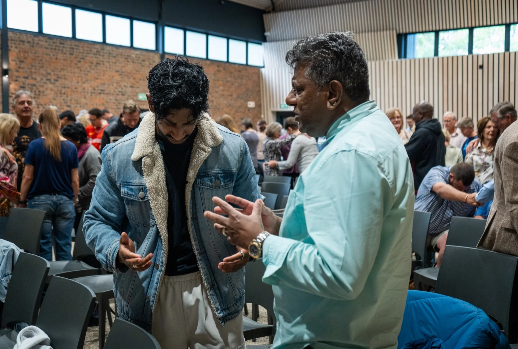 A church member worshipping with hands raised
